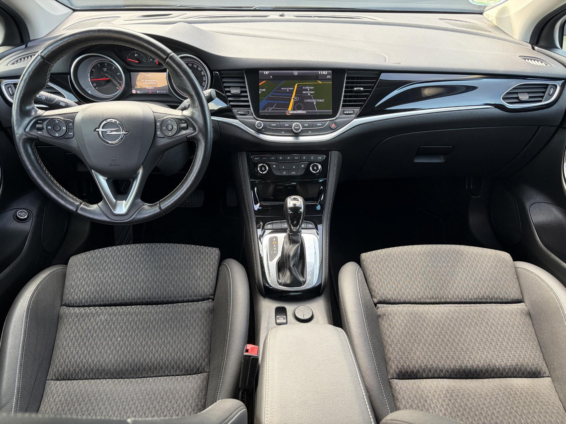 Opel Astra Sports Tourer 1.4 Business Executive ✓2 Eigenaar✓Camera✓Navi✓Trekhaakt✓Carplay✓Stoelverw✓Stuurverw✓Automaat✓Dealer Onderhouden✓Keyless✓Clima✓Cruise✓Pdc V+A✓Halfleder✓Comfortstoelen✓150pk✓Rijstrooksensor✓Dodehoeksensor✓Elekt Stoelen✓Lm velgen✓N.